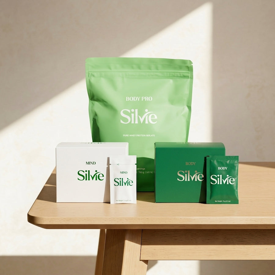 Silvie supplement packagings, boxes and protein powder package on a wooden table..