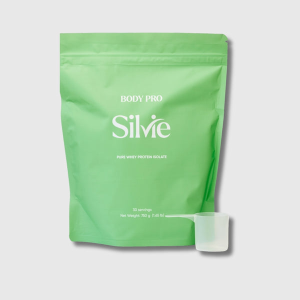 A light green stand-up pouch of Body Pro Silvie pure whey protein isolate, shown on a light gray background with a small translucent scoop in front.
