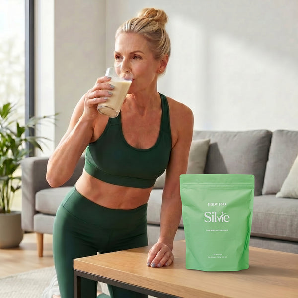 Woman 55+ drinking Silvie Body Pro whey isolate protein with water