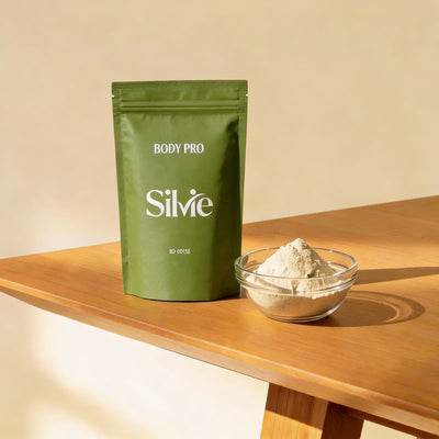 Green Silvie BODY PRO doypack with a bowl of powder on a wooden surface
